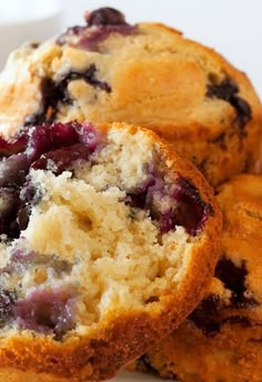 a muffin with blueberries is sitting on top of some other muffins