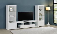 a white entertainment center with shelves and a flat screen tv mounted on it's side