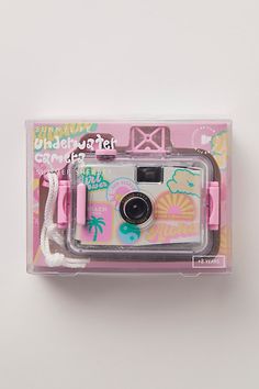 a pink and white polaroid camera in its packaging