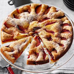 a pie with slices cut out on a glass platter