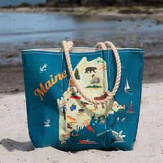 a blue bag sitting on top of a sandy beach