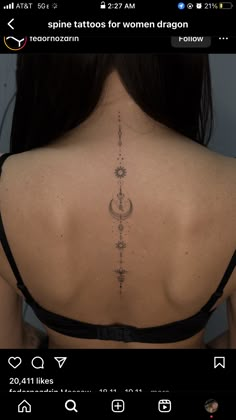 the back of a woman's neck with tattoos on her upper and lower back