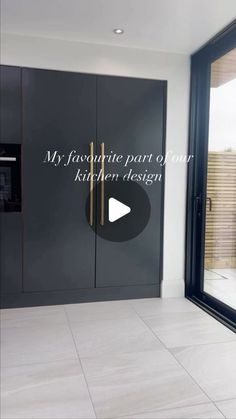 a kitchen with black cabinets and white flooring next to a sliding glass door that reads, my favorite part of our kitchen design