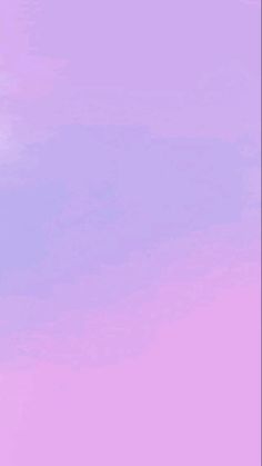 an airplane is flying in the sky with a pink and purple hue to it's left