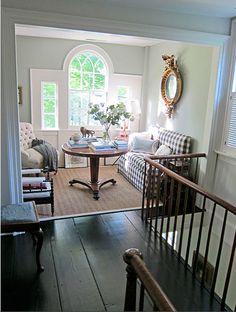 a living room filled with furniture next to a window