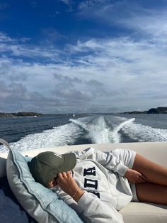 a person laying on the back of a boat