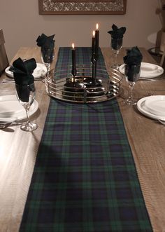 Make your holiday table stand out with the classic Black Watch tartan table runner. Its timeless navy, green, and black plaid design adds a sophisticated touch to your festive table setting, while also creating a cozy, relaxed feel for your country home. Perfect as a striking accent for your holiday dishes or as a stylish runner on your mantle, this versatile piece brings elegance and warmth to any décor. The tartan table runner is made of polyviscose fabric with a coordinating rolled hem edging Scottish Christmas Table Settings, Classy Christmas Party Ideas, Black Watch Plaid Christmas, Tartan Christmas Decorations, Air Force Families, Holiday Mantle, Festive Table Setting, Holiday Dishes, Canadian Maple Leaf