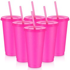 six pink plastic cups with straws in them are lined up against a white background