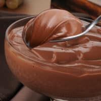 a spoon in a bowl filled with chocolate