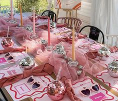 the table is set up with pink and silver decorations for valentine's day dinner