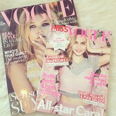 two magazines sitting on top of a white furnishing covered floor next to each other