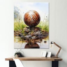 a golf ball sitting on top of a wooden table next to a water hole with grass and rocks