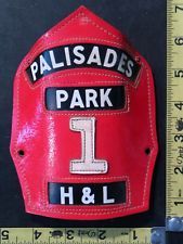 a red baseball glove with the number 1 on it is next to a measuring ruler