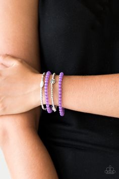 Mismatched silver beads and strands of glassy purple beads are threaded along stretchy bands. Infused with silver accents, dainty rose blossoms adorn the wrist for a seasonal finish.

Sold as one set of four bracelets. Dainty Rose, Purple Beads, Purple Bracelet, Silver Frames, Paparazzi Accessories, Rock Stars, Stretchy Bracelets, Paparazzi Jewelry, Flower Charm