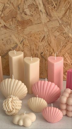 candles and seashells are arranged on a table