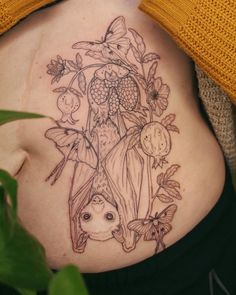 a woman's stomach with an image of flowers and plants on the bottom side