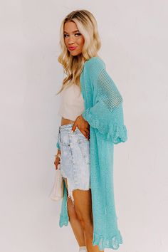 Relax in the summer evening breeze with this cute turquoise cardigan featuring lightweight knit material, oversized half sleeves, ruffle trim detailing, and a draped open front silhouette that falls into a straight mid-calf length hemline! Measurements S : Bust 46", Hip 44", Length 38", Sleeve Length 19", Waist 44". M : Bust 48", Hip 46", Length 39", Sleeve Length 19", Waist 46". L : Bust 50", Hip 46", Length 39", Sleeve Length 19.5", Waist 46". Flowy V-neck Cardigan For The Beach, Chic Beach Cover-up Cardigan For Beach Season, Spring Vacation Open Front Duster, Long Sleeve Summer Layering Cover-up, Open Front Duster For Spring Vacation, Spring Beach Cover-up Duster, Spring Beach Cover-up Duster Open Front, Spring Knit Cover-up For Day Out, Spring Open Front Duster For Beach