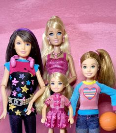 four dolls standing next to each other in front of a pink wall with a basketball ball