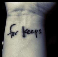 a wrist tattoo with the words for keeps written on it