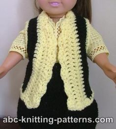 a doll wearing a black and yellow crochet vest