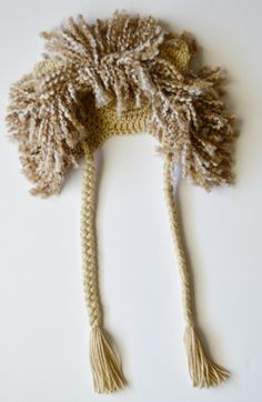 a crocheted hat with two tassels on it