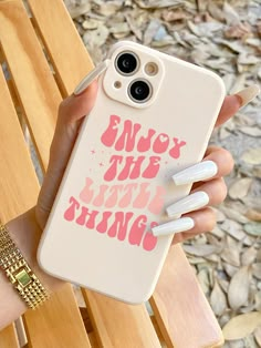 a person holding an iphone case with the words enjoy the little things on it