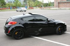 a black sports car parked in a parking lot