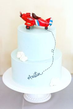 a blue cake with a red plane on top