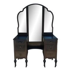 an antique vanity with mirror and two drawers