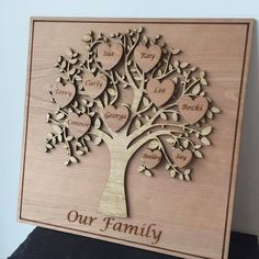 a wooden family tree with hearts on it