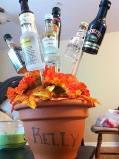 a potted planter filled with liquor bottles and flowers