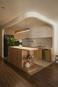 a kitchen with wooden floors and white walls