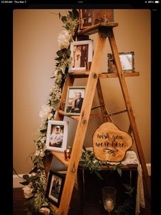 a wooden ladder with pictures and flowers on it