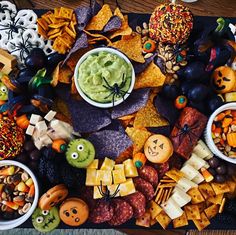 a table topped with halloween snacks and crackers