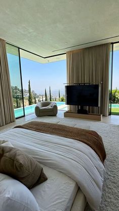 a large bed sitting in the middle of a living room next to a flat screen tv