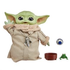 the child yoda doll is posed next to its toy companion, and includes accessories