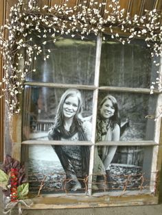 an old window with two girls in it