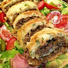 some food is laying on a plate with lettuce, tomatoes and other vegetables