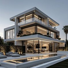 a modern house with an outdoor pool and lounge area in front of it at dusk