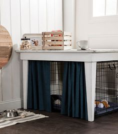 a dog kennel with its door open on the floor