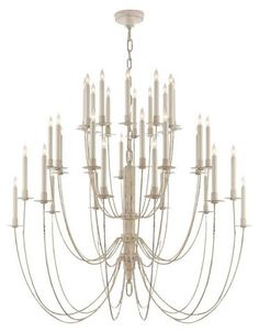 a large chandelier with many white candles hanging from it's center point