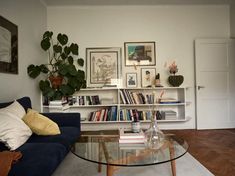 a living room filled with furniture and a glass table