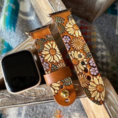 an apple watch band with flowers on it