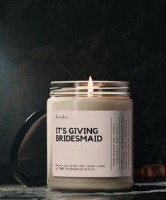 a candle that reads it's giving bridesmaid on the front and side