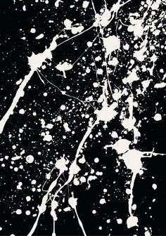 white paint splattered on black paper