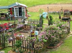 an aerial view of a garden with lots of potted plants and flowers on the ground