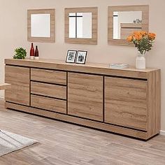 the sideboard is made out of wood and has two mirrors on top of it