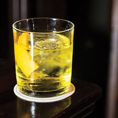 a glass filled with liquid sitting on top of a table