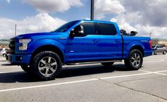 a blue truck parked in a parking lot