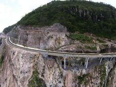 an aerial view of a highway going over a cliff